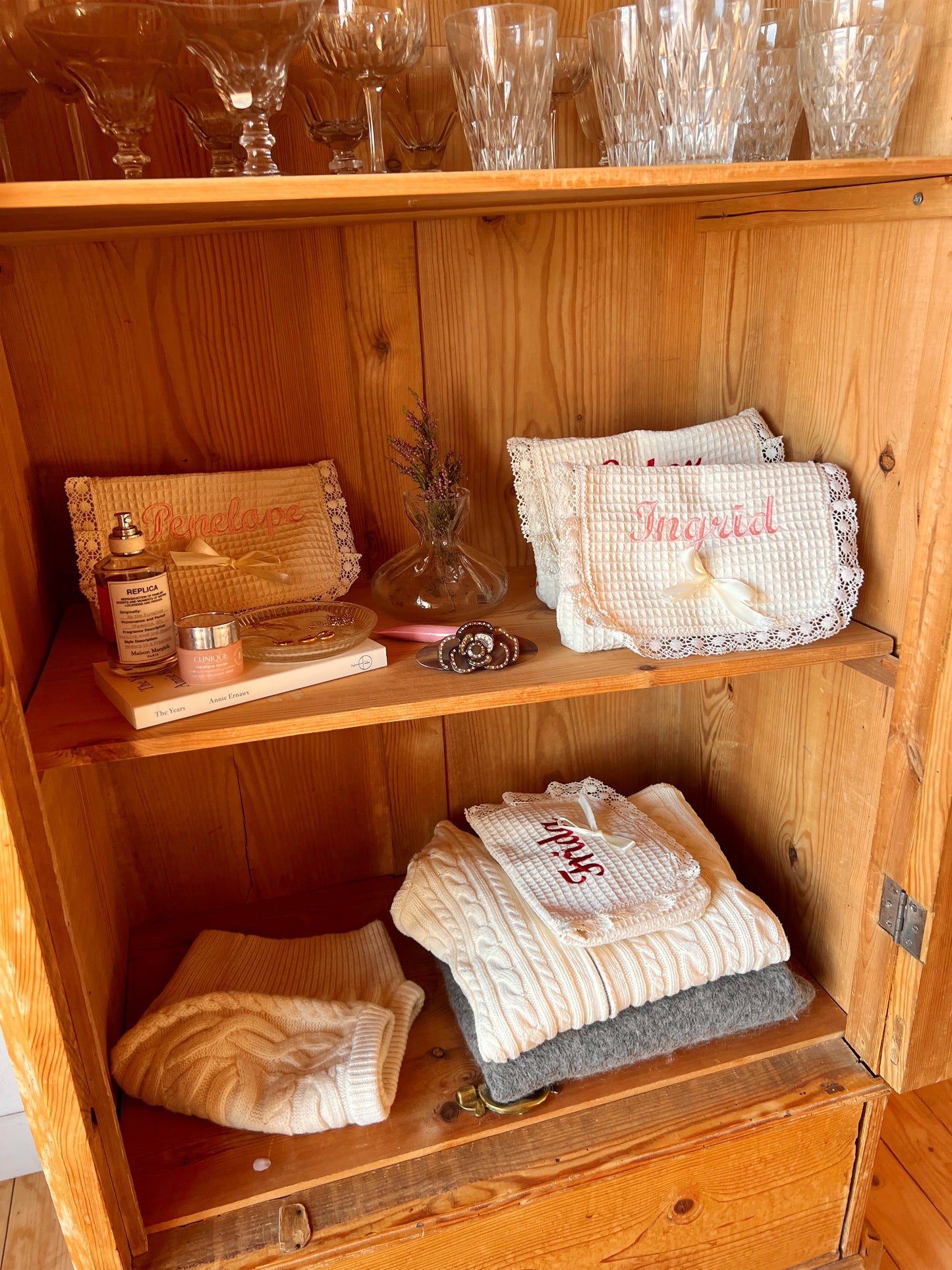 Personalized embroidered makeup bag in closet. Pinterest aesthetic.