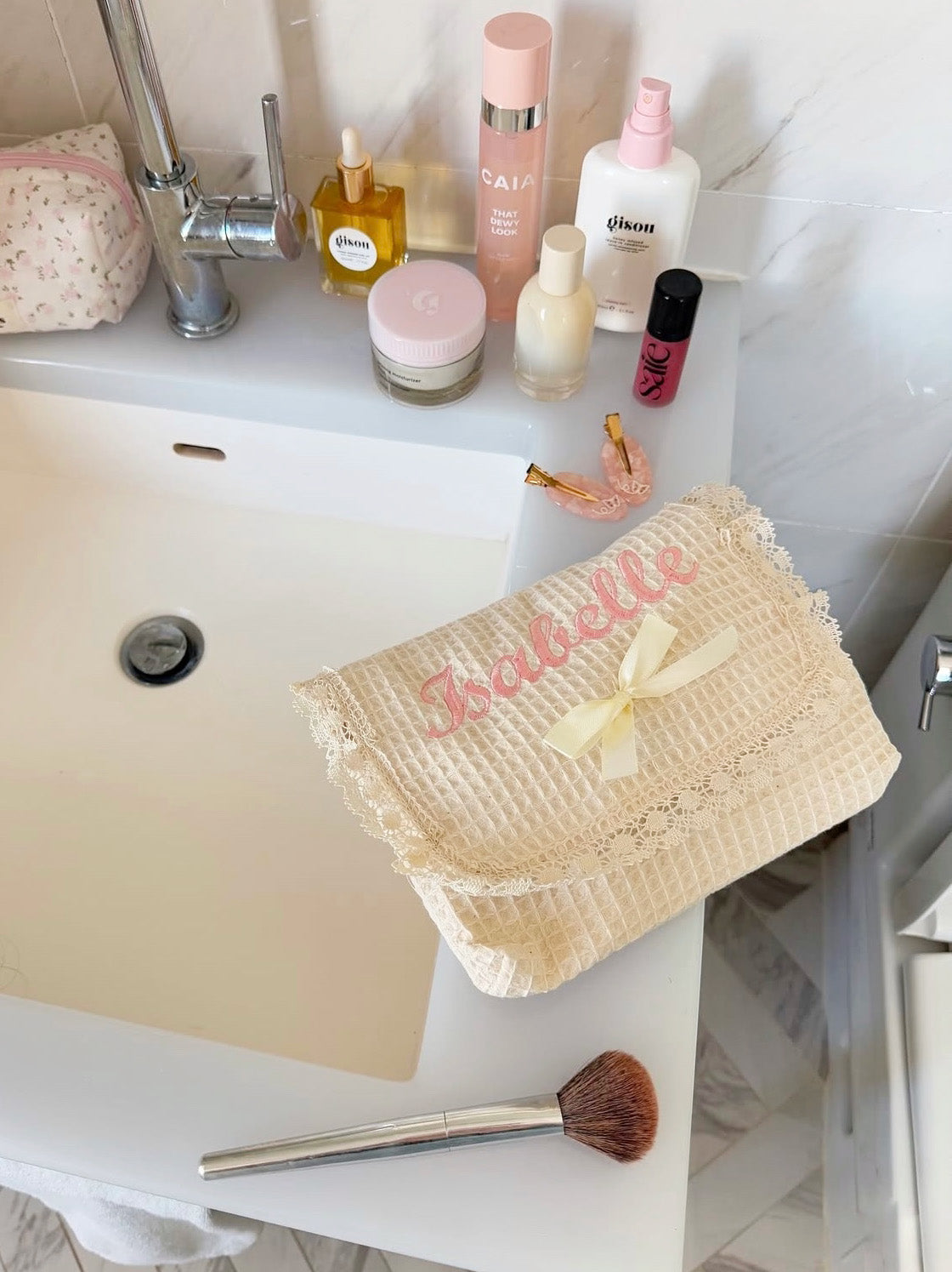 Personalized and Custom embroidered makeup bag in waffle weave cotton on the bathroom zink. Perfect for travel and beauty essentials.
